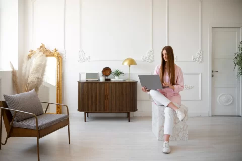 woman using laptop minimal decorated room