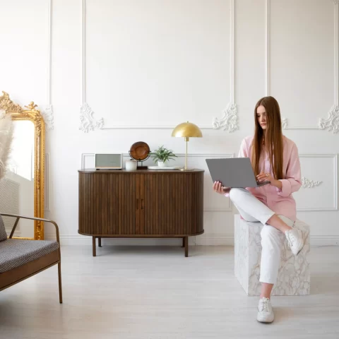 woman using laptop minimal decorated room